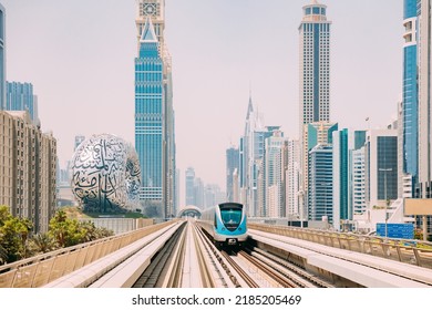 Monorail Subway train rides among glass skyscrapers in Dubai. Traffic on street in Dubai. Museum of the Future in Dubai. Cityscape skyline. Urban background.