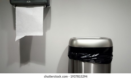 Monotone Paper Towel Dispenser And Trash Can In Public Restroom