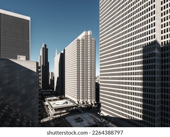 Monotone skyscrapers lit by morning sunshine stand out against a deep blue sky in San Francisco, USA