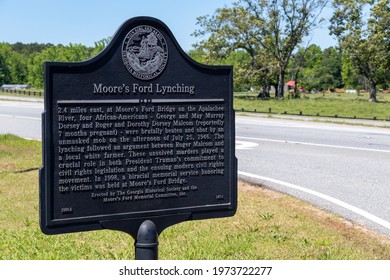 Monroe, Georgia – May 14, 2021: Close-up of the roadside historical marker pointing to the site of the lynching of four African Americans by an unmasked mob on July 25, 1946. 