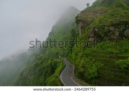 Monsoon clouds passing over Gidda Pahar, Kurseong, Himalayan mountains of Darjeeling, West Bengal, India. Darjeeling is queen of hills and very scenic with beautiful green hills in rainy season.