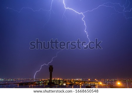 Monsoon thunderstorm over airport control tower