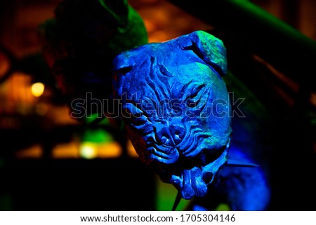 A Monster Dog Head Sculpture. Vibrant Blue and Green Scary Beast