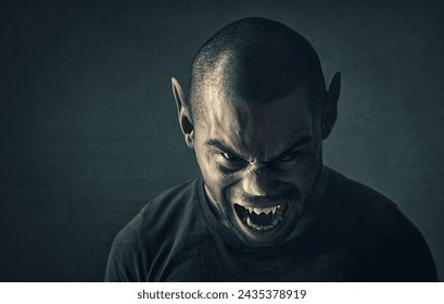 Monster, man and face with horror in studio for fantasy, demon and angry vampire with fangs, scary and terror. Werewolf, devil and creepy creature with shouting, rage and surreal on black background