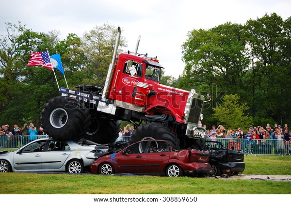 Monster Truck\
Challenge at Truckmania, Beaulieu, England - May 24, 2015: The Big\
Pete jumping cars at\
Truckmania
