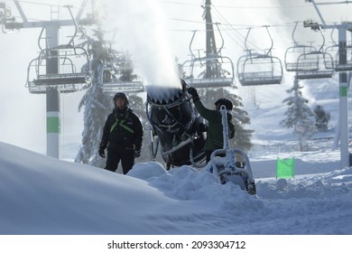 Mont Saint Bruno Ski Resort, Québec, Canada, December 18 2021, Ski Resort Worker With Snow Cannon And Snow Plow