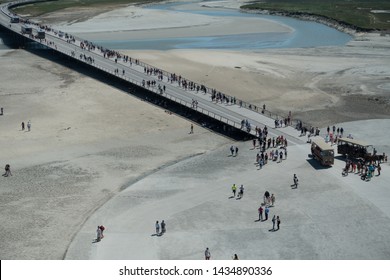 Mont St Michel / France - June 1, 2019: View From Above Of Tourists Arriving And Leaving On Bus And Horse And Cart At Le Mont St Michel - Image