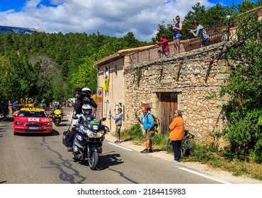 Mont Ventoux, France - July 14,2016: Official Broadcasting Bike And The Red Car, Driving On The Road To Mont Ventoux, During The Stage 12 Of Tour De France 2016. 