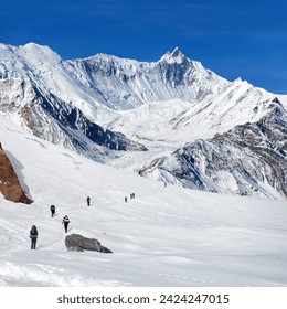 montage of hikers on glacier and Mount Khangsar Kang, Annapurna circuit trekking trail, Nepal Himalayas mountains