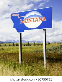 Montana state sign with Rocky Mountains in the distance./ Montana State Sign