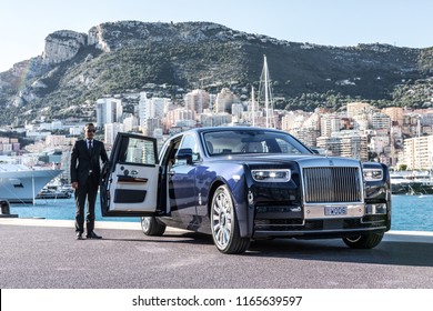 Monte - Carlo, Monaco 26 August 2018 Rolls - Royce Phantom VIII 8, In Port With City And Yachts At Background Driver Opened Door.