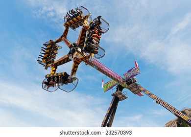 MONTE CARLO, MONACO - NOVEMBER 2, 2014: People Wait Up In The Blue Sky For The Vertical Ride And The Zero Gravity Thrill At An Amusement Park