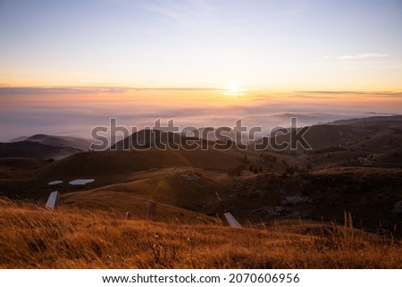 monte grappa view at sunset with sea of clouds