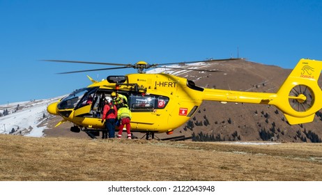 Monte Pora. Bergamo. Italy. February 5, 2022. Rescue Helicopter Over The Mountains To Help Hikers. First Aid Helicopter. Team Ready For Emergency Response. Medical Rescue Helicopter On The Ground