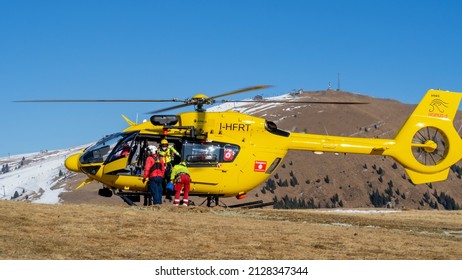 Monte Pora. Bergamo. Italy. February 15, 2022. Rescue Helicopter Over The Mountains To Help Hikers. First Aid Helicopter. Team Ready For Emergency Response. Medical Rescue Helicopter On The Ground