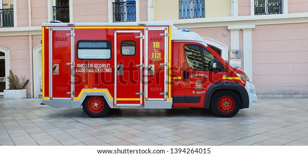Monte-Carlo, Monaco - March 28, \
French Red And White Fire Department Ambulance Van (Side View)\
Parked In The Street Of Monaco, With Lights, French Riviera,\
France, Europe