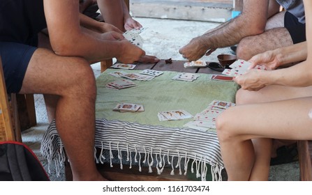 Montegiordano, Italy - August 19, 2018: Summer Activities, Small Group Of People Playing Cards