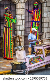 Montego Bay, Jamaica - March 20 2018: Jamaican Workers On The Job - Mascots With Long Legs And A Fruit Vendor - At Margaritaville On The Hip Strip/ Jimmy Cliff Boulevard In Montego Bay City, Jamaica