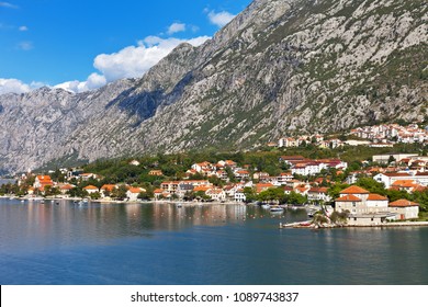 Montenegro. Boka Kotor Gulf. View On The Picturesque Coastal Town Of Dobrota, The Institute Of Marine Biology And The Church Of St. Ilijah 