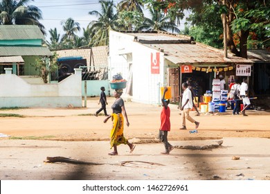 Montepuez, Mozambique-2016-12-06: Mozambique women and children carrying basket on the head and walking at Montepuez, Mozambique