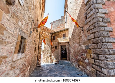 Montepulciano, Italy - August 28, 2018: Narrow Alley Empty Street Path In Small Town Village In Tuscany With Flags And Entrance To Laundry Laundromat