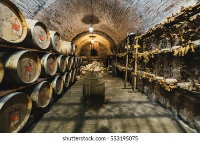 Montepulciano, Italy - November 1, 2016: Oak barrels in an old Italian wine cellar.