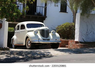 Monterey, CA, USA - 18 Aug 2022: Beautiful, Classic Cream Colored DeSoto In Pristine Condition Is Parked In A Driveway In Monterey During Classic Car Week.