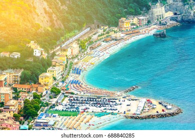 Monterosso Al Mare, A Coastal Village And Resort In Cinque Terre, Italy. Umbrellas And Seats Aligned On A Sandy Beach