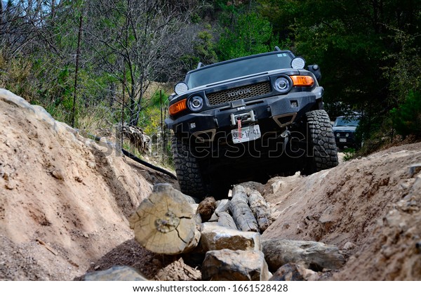Monterrey Nuevo Leon,\
Mexico. February 29, 2020. Toyota land cruiser in  a difficult \
obstacle in the \
road.