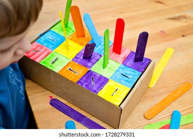 Montessori Implement. Sorting By The Colors. DIY At Home From Cardboard Box And Ice-cream Sticks. Easy 5 Minute Craft. Early Preshool Eduaction For Toddlers.