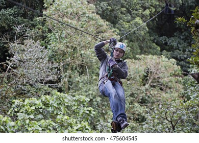 MONTEVERDE, COSTA RICA - November 25 2008: Asian Playing Zipline In The Canopy In Monteverde, Costa Rica.