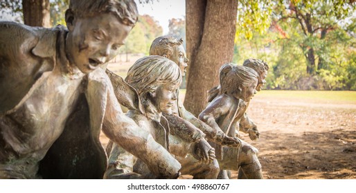 MONTGOMERY, ALABAMA - OCTOBER 15, 2016:
Statue Of Kids Playing, Unmarked And Unnamed 
 Statue Of Children Playing At The Alabama Shakespeare Festival In Montgomery, Alabama.  Focus On Second Child In.