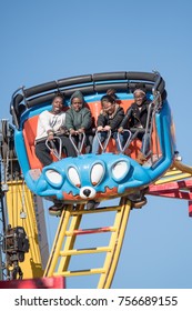 Montgomery, Alabama, USA - October 29, 2017: Three African American Children And An Asian Child Enjoy The Roller Coaster At The Alabama National Fair.