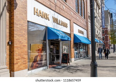 Montgomery, Alabama/USA-January 20, 2018: A Couple Walks Down The Sidewalk On Commerce Street Near The Hank Williams Museum.