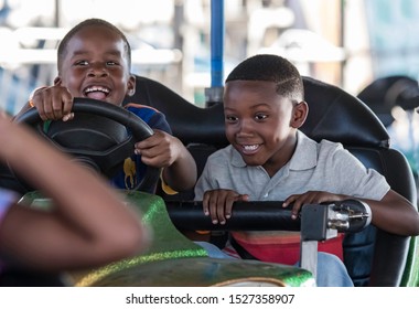 Montgomery, Alabama/USA-October 6, 2018: Two Young African American Boys Enjoy The Bumper Cars At The Alabama National Fair In Montgomery.