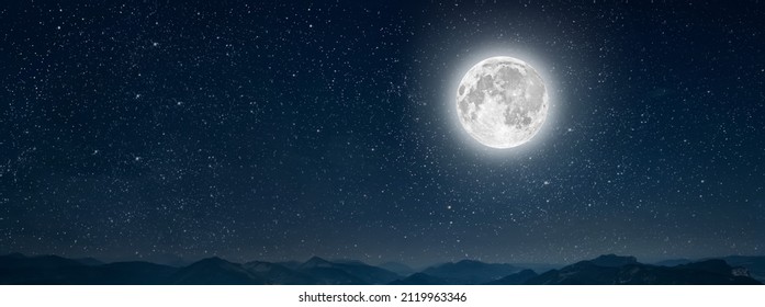 month on a background stars the sky shines over the mountains - Powered by Shutterstock