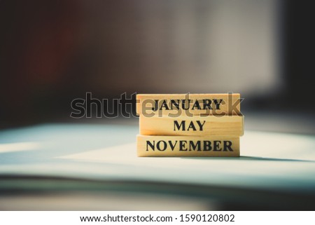 Month wooden character using as business aconcept