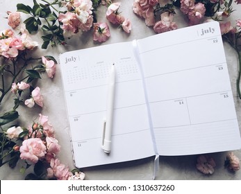 Monthly Planner Open On A Month Of July With Pink Roses Around