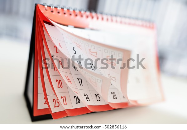Months and dates shown on a calendar whilst turning\
the pages
