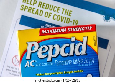 Montreal, CA - 27 April 2020: Box Of Pepcid AC Antacid Medicine In Front Of A Covid-19 Prevention Document