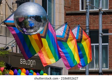 Montreal, CA - 5 August 2022: Disco Ball And LGBTQ Progress Pride Flags During Pride Week 