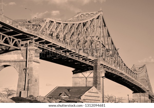 MONTREAL CANADA\
02 07 2019: The Jacques Cartier Bridge is a steel truss cantilever\
bridge crossing the Saint Lawrence River from Montreal to Longueuil\
in Montreal, Quebec,\
Canada