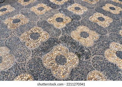 Montreal, Canada -2022: Chinese Pebble Decorative Walkway Of Artistic Designs. Reflexology Paths. Walking Path Made Of Smooth River Rocks On Edge, Packed Close Together, Embedded In Concrete.