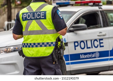 Montreal, Canada - 22 September 2019: Rear View Of A Policeman In Front Of A Police Car.