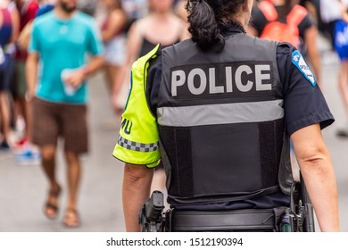 Montreal, Canada - 22 September 2019: Rear View Of A Policewoman At The Montreal Marathon.