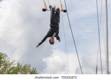Montreal, Canada - 4 June 2017: Trapeze artist performing outside In Jeanne Mance Park