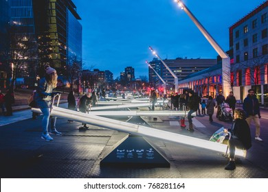 Montreal, Canada _ December 3, 2017. Place Des Arts Square are Night with Kids and Parents having Fun on Seesaws that Change Light Intensity and also Makes Music.