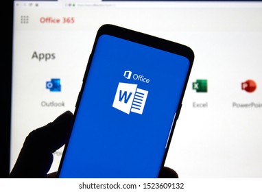 MONTREAL, CANADA - APRIL 24, 2019: A cell phone with Microsoft Word logo over a laptop screen. Microsoft Office is a family of client-server software and services developed by Microsoft.