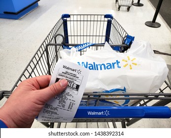 MONTREAL, CANADA - APRIL 30, 2019: Walmart shopping cart with bag and receipt in Walmart store. Walmart is an American retail corporation that operates a chain of hypermarkets and discount stores