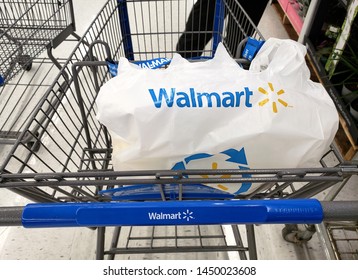 MONTREAL, CANADA - APRIL 30, 2019: Branded Walmart shopping cart and bag in Walmart store. Walmart is an American retail corporation that operates a chain of hypermarkets and discount department store